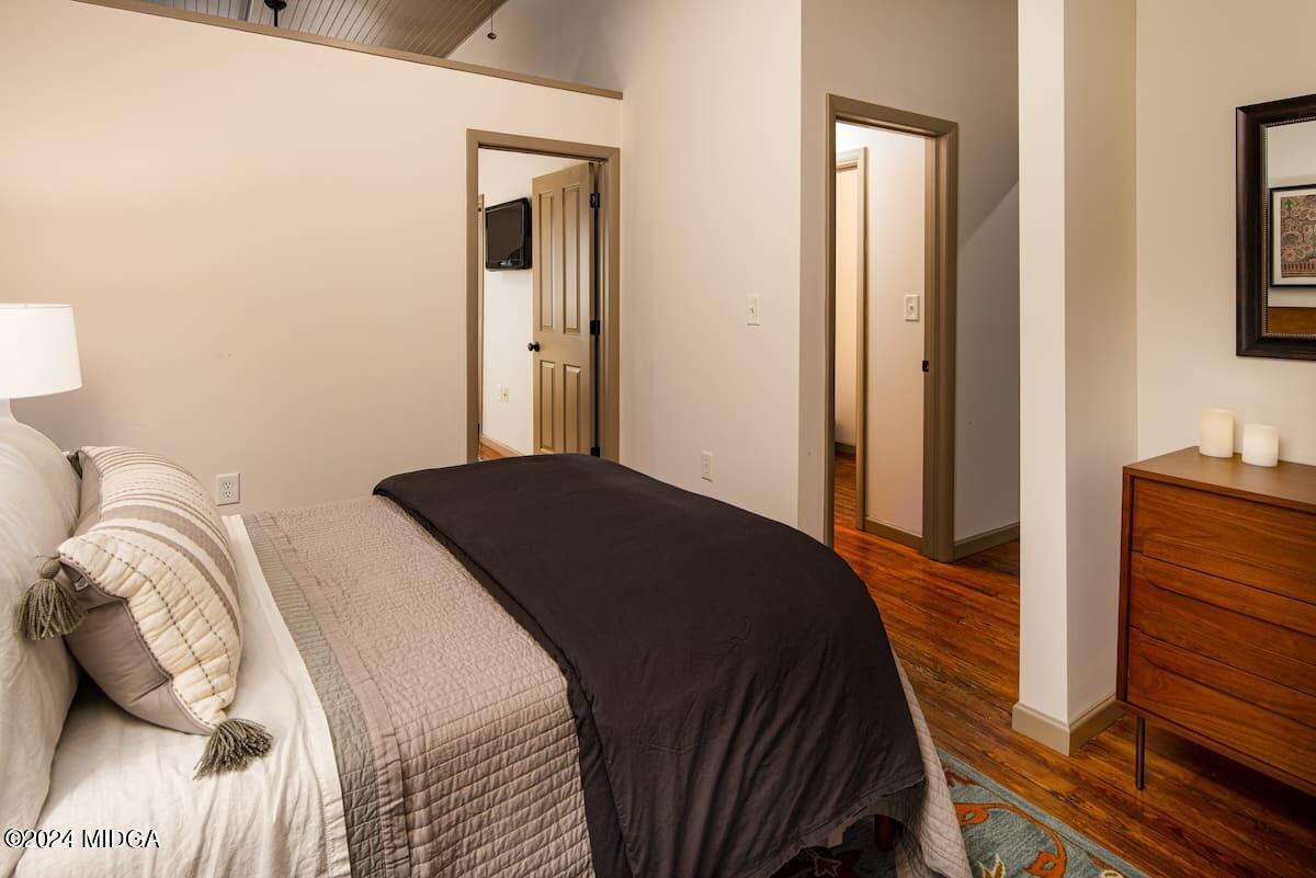 617 Cherry Street, Unit C Macon, GA 31201 - Photo 6 of 10 a bedroom with a bed and a mirror