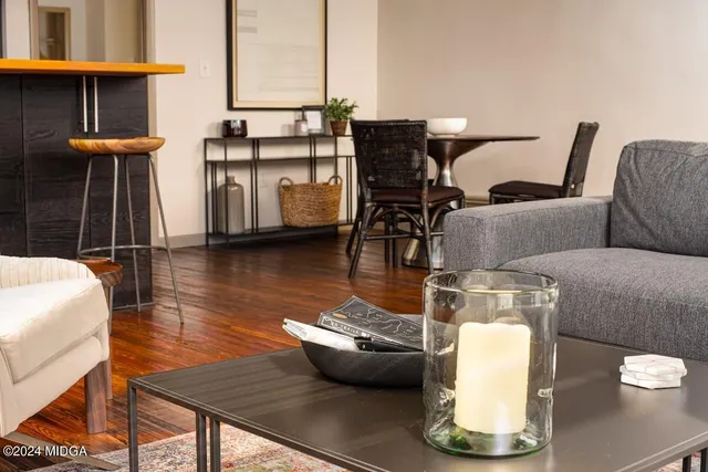 a living room with furniture and wooden floor
