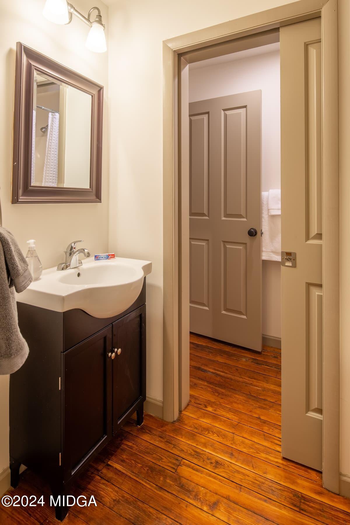 617 Cherry Street, Unit C Macon, GA 31201 - Photo 8 of 10 a bathroom with a sink vanity and a mirror