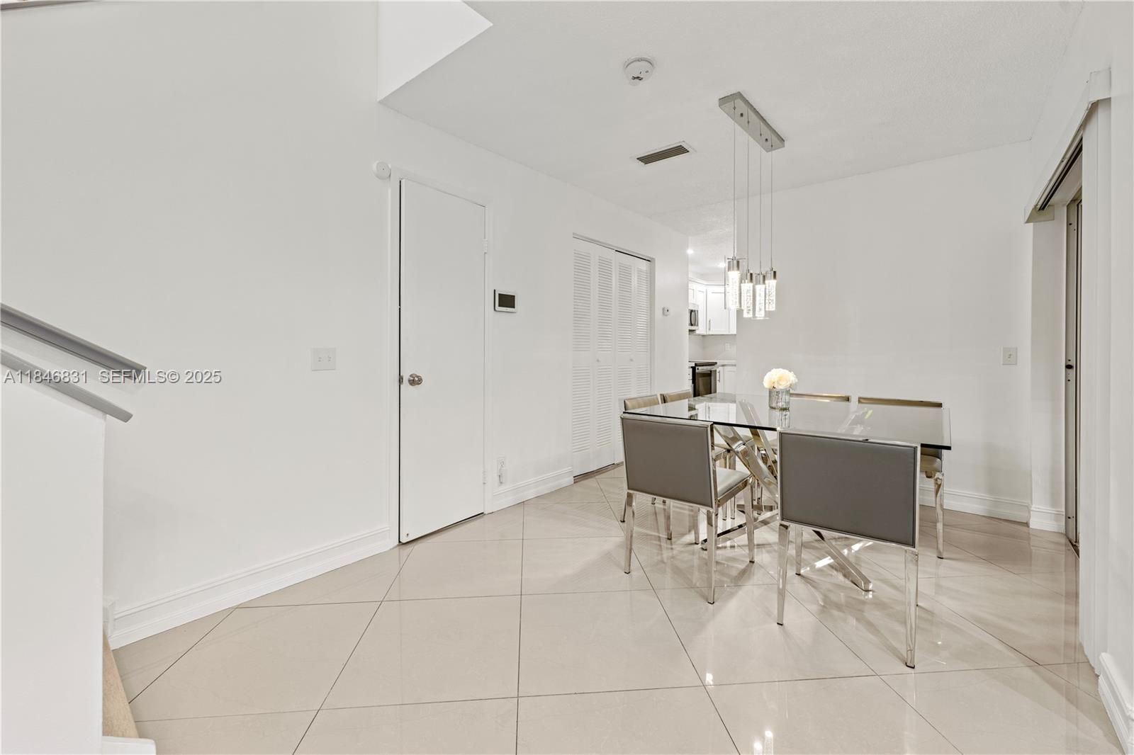 6603 Via Regina, Unit 50 Boca Raton, FL 33433 - Photo 11 of 48 a dining room with furniture and window