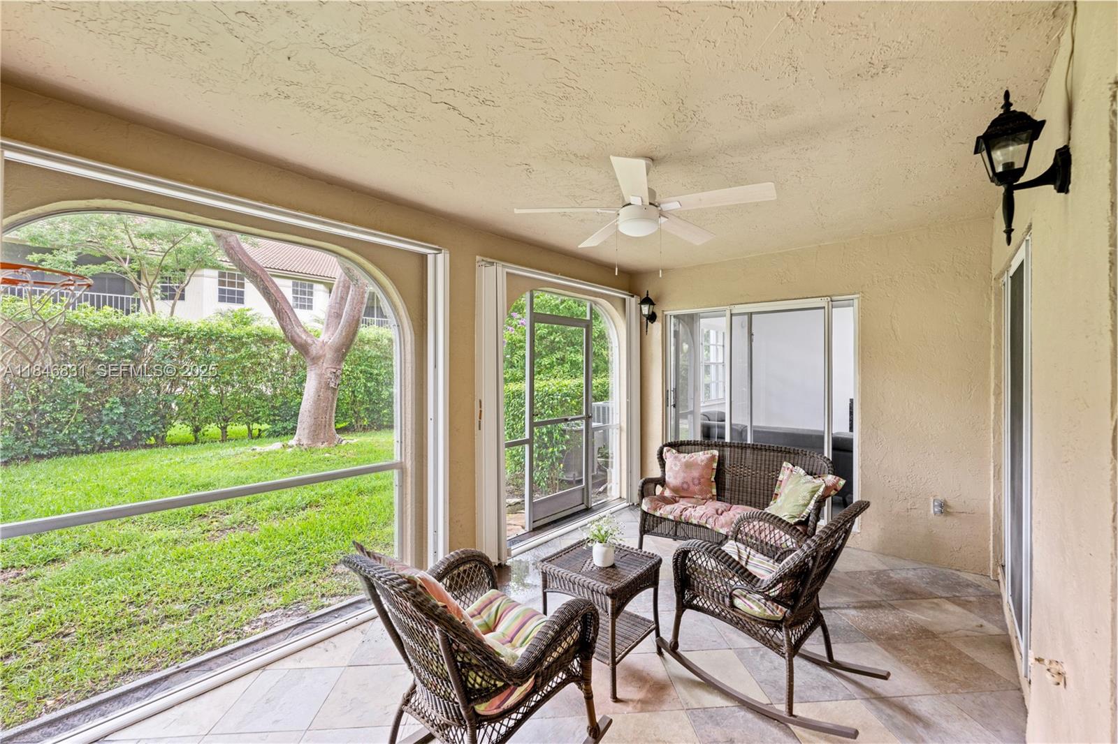 6603 Via Regina, Unit 50 Boca Raton, FL 33433 - Photo 19 of 48 a living room with a couch and a table