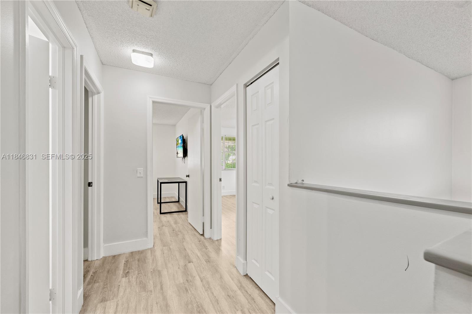 6603 Via Regina, Unit 50 Boca Raton, FL 33433 - Photo 23 of 48 a view of a hallway with wooden floor and closet