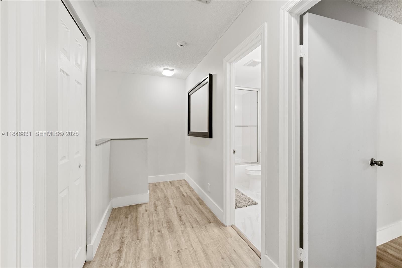 6603 Via Regina, Unit 50 Boca Raton, FL 33433 - Photo 24 of 48 a view of a hallway with wooden floor and entryway