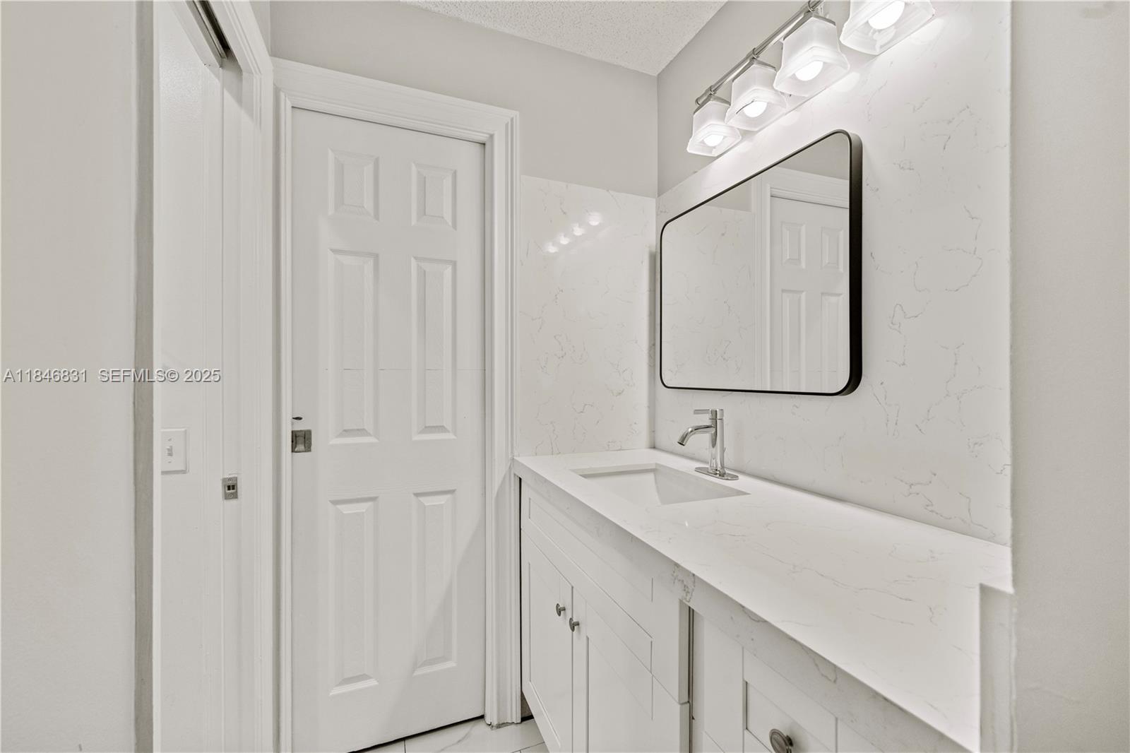 6603 Via Regina, Unit 50 Boca Raton, FL 33433 - Photo 27 of 48 a bathroom with a sink and a mirror