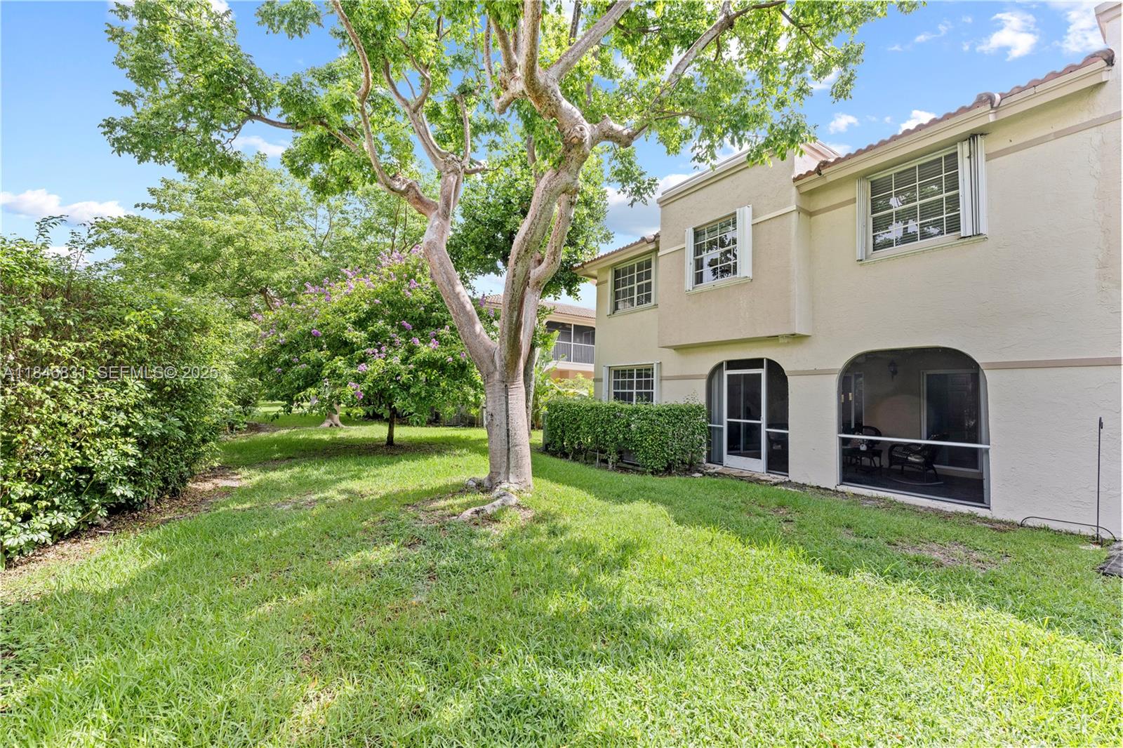 6603 Via Regina, Unit 50 Boca Raton, FL 33433 - Photo 43 of 48 a view of backyard with seating area and trees