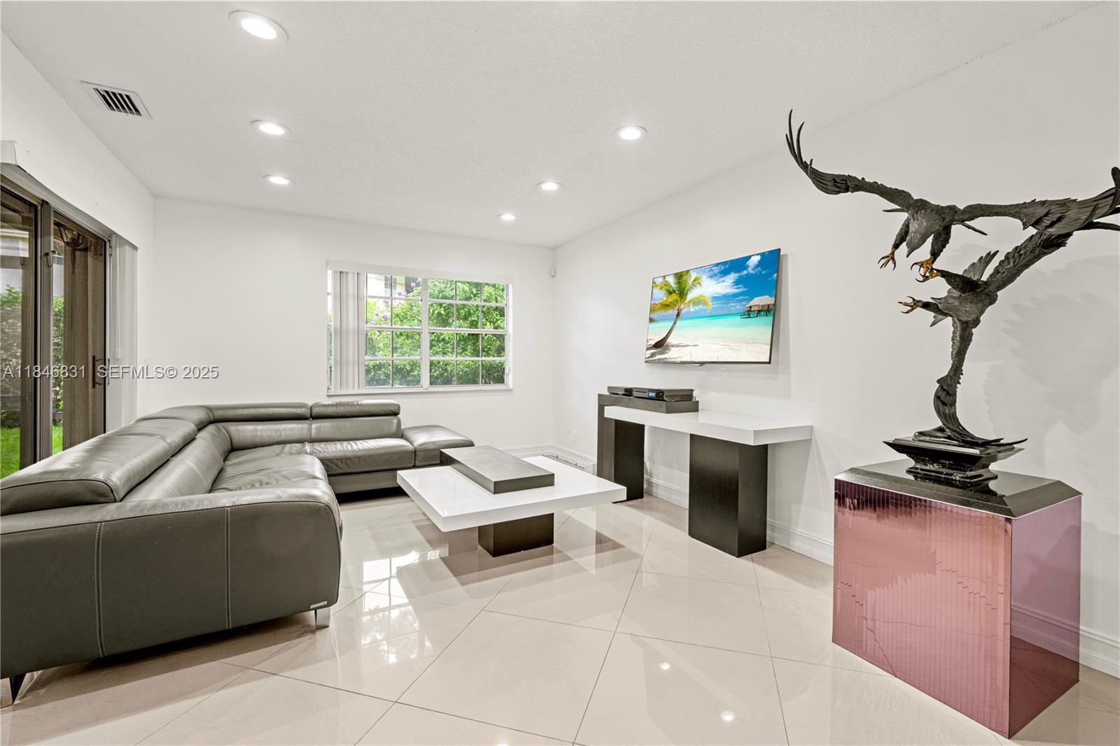 6603 Via Regina, Unit 50 Boca Raton, FL 33433 - Photo 7 of 48 a living room with furniture a window and a fireplace