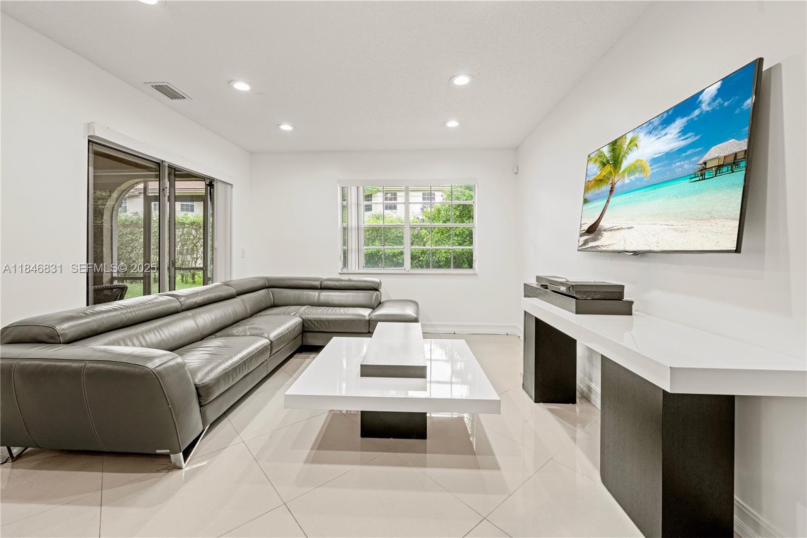 6603 Via Regina, Unit 50 Boca Raton, FL 33433 - Photo 8 of 48 a living room with stainless steel appliances furniture and a large window