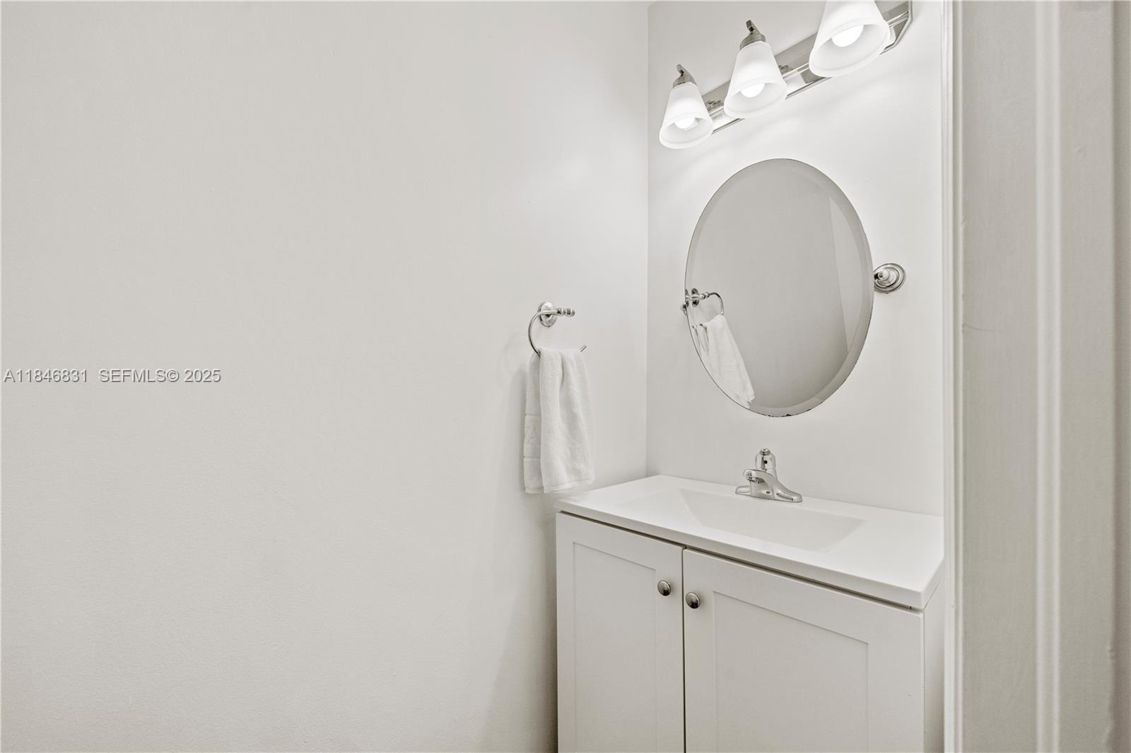 6603 Via Regina, Unit 50 Boca Raton, FL 33433 - Photo 10 of 48 a bathroom with a sink and a mirror