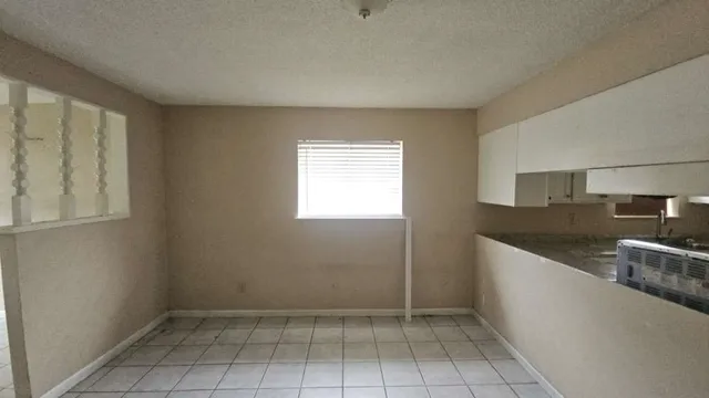 a view of a kitchen with granite countertop a sink and dishwasher in a kitchen