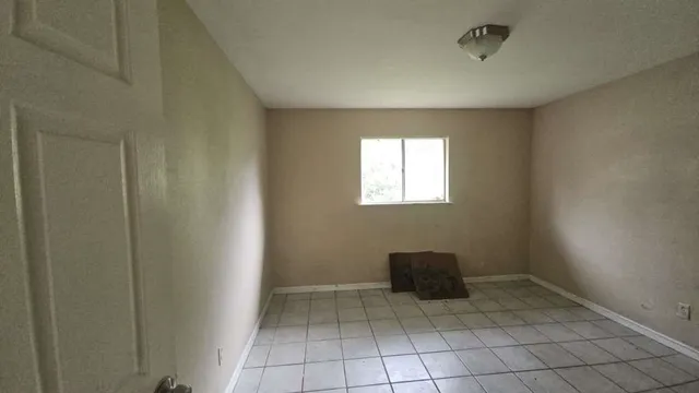 a view of an empty room and window