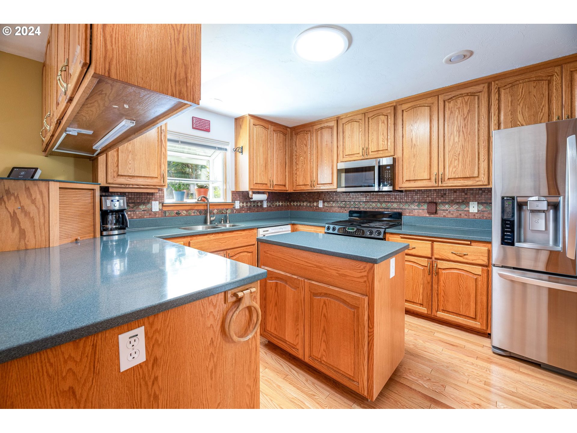 1769 Carriage Place Springfield, OR 97477 - Photo 16 of 23 a kitchen with stainless steel appliances granite countertop a stove a sink and a microwave