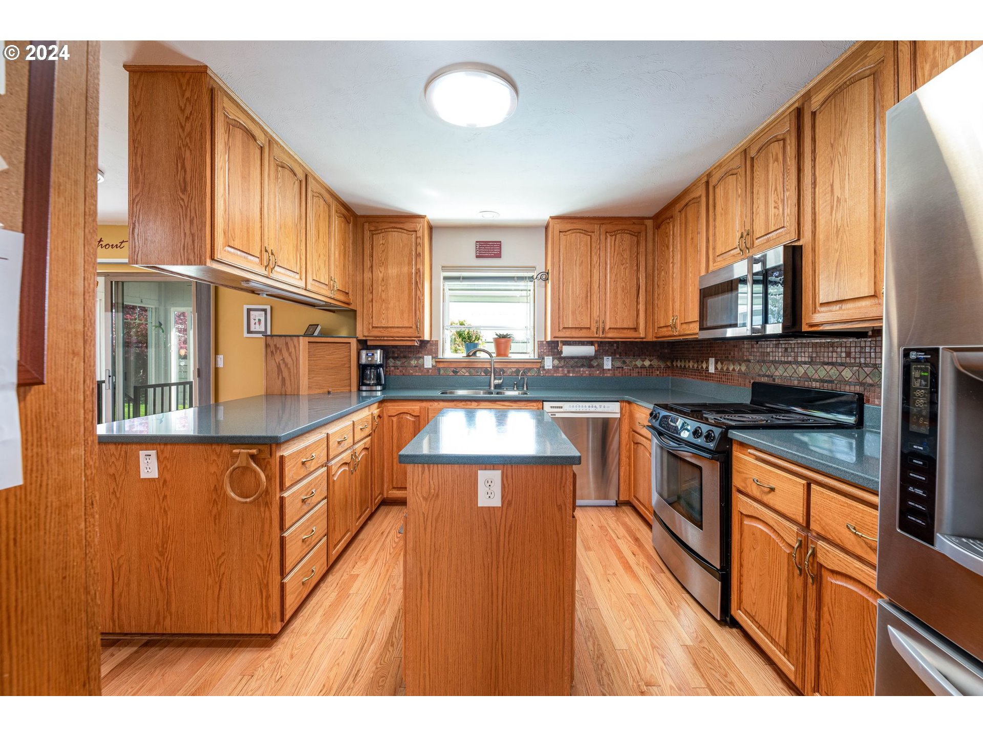 1769 Carriage Place Springfield, OR 97477 - Photo 17 of 23 a kitchen with stainless steel appliances granite countertop a stove a sink dishwasher and a refrigerator