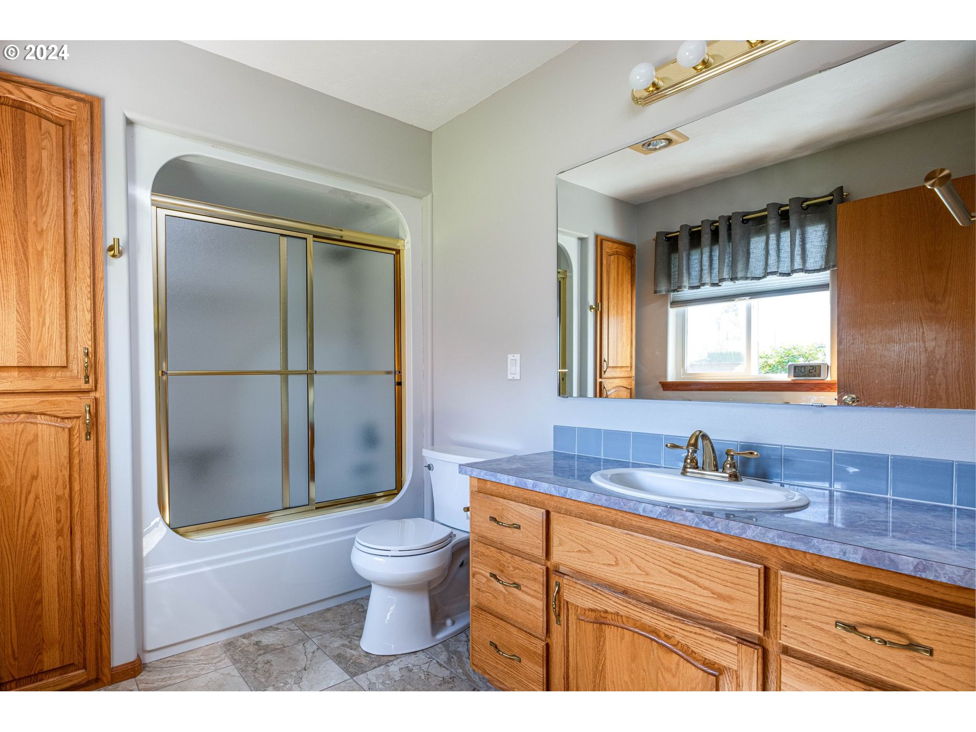 1769 Carriage Place Springfield, OR 97477 - Photo 22 of 23 a bathroom with a granite countertop sink toilet a mirror and shower