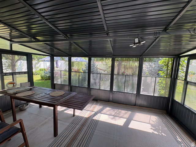 922 North 480 West Logan, UT 84321 - Photo 8 of 11 Sunroom featuring a dark-toned metal frame, clear and opaque paneling, and a corrugated ceiling
