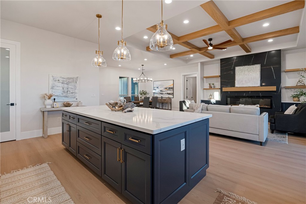 500 Sunset Drive Paradise, CA 95969 - Photo 17 of 43 a kitchen with kitchen island a sink and a stove with wooden floor
