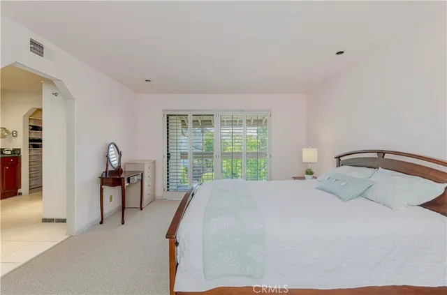 a bathroom with a granite countertop sink a toilet a mirror a bathtub and shower