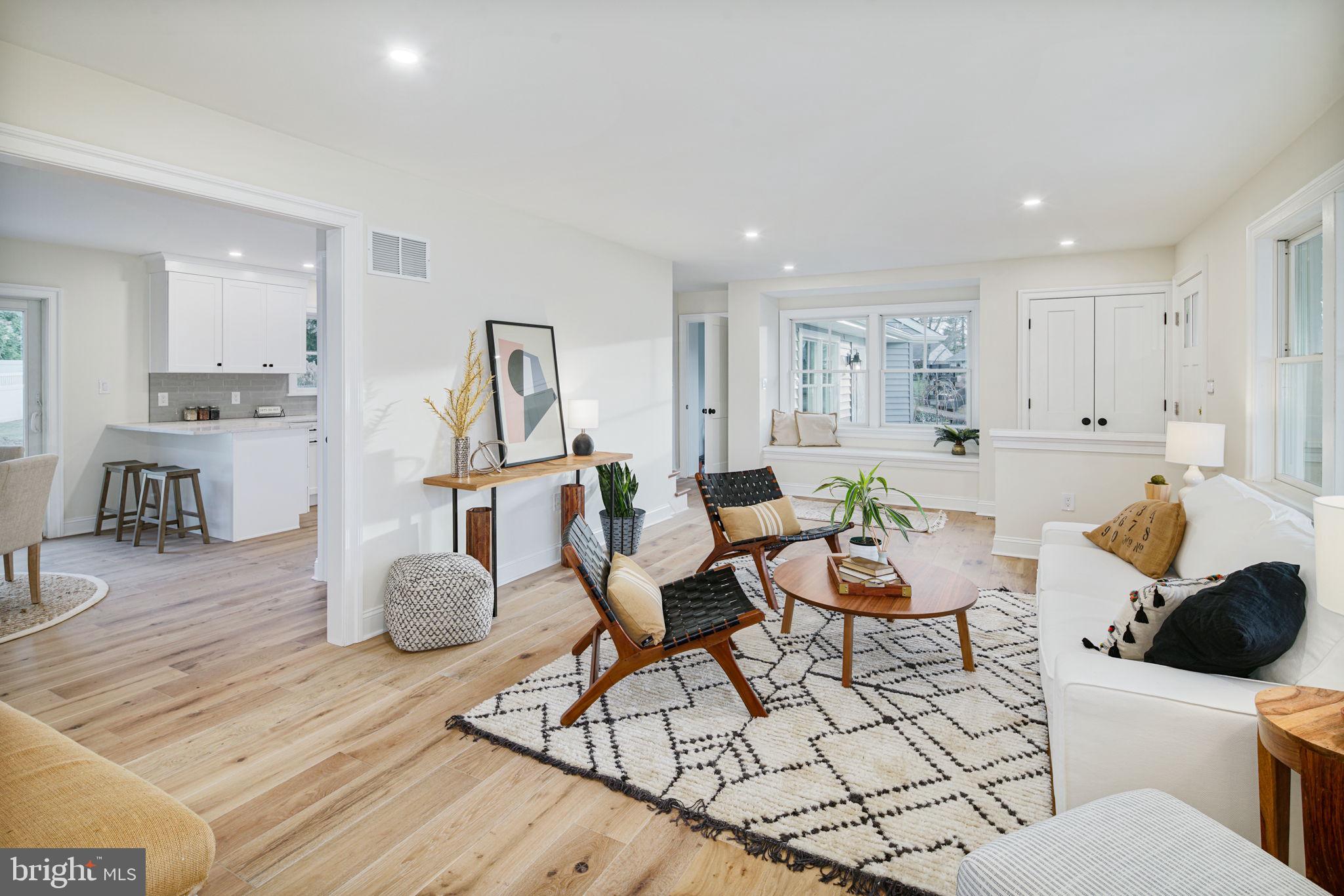 745 Cedar Avenue Haddonfield, NJ 08033 - Photo 11 of 55 a living room with furniture a wooden floor and a kitchen view
