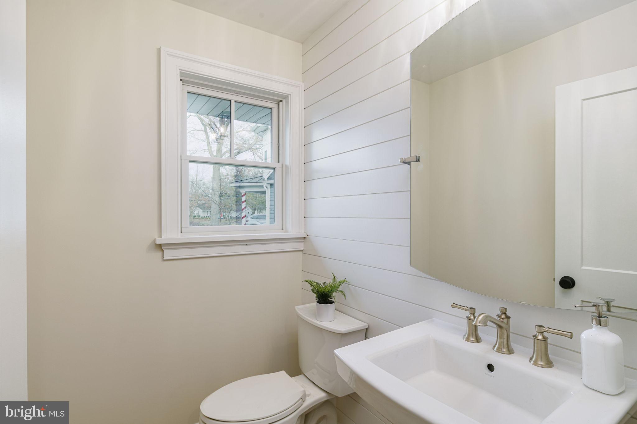 745 Cedar Avenue Haddonfield, NJ 08033 - Photo 27 of 55 a bathroom with a toilet a sink and a window