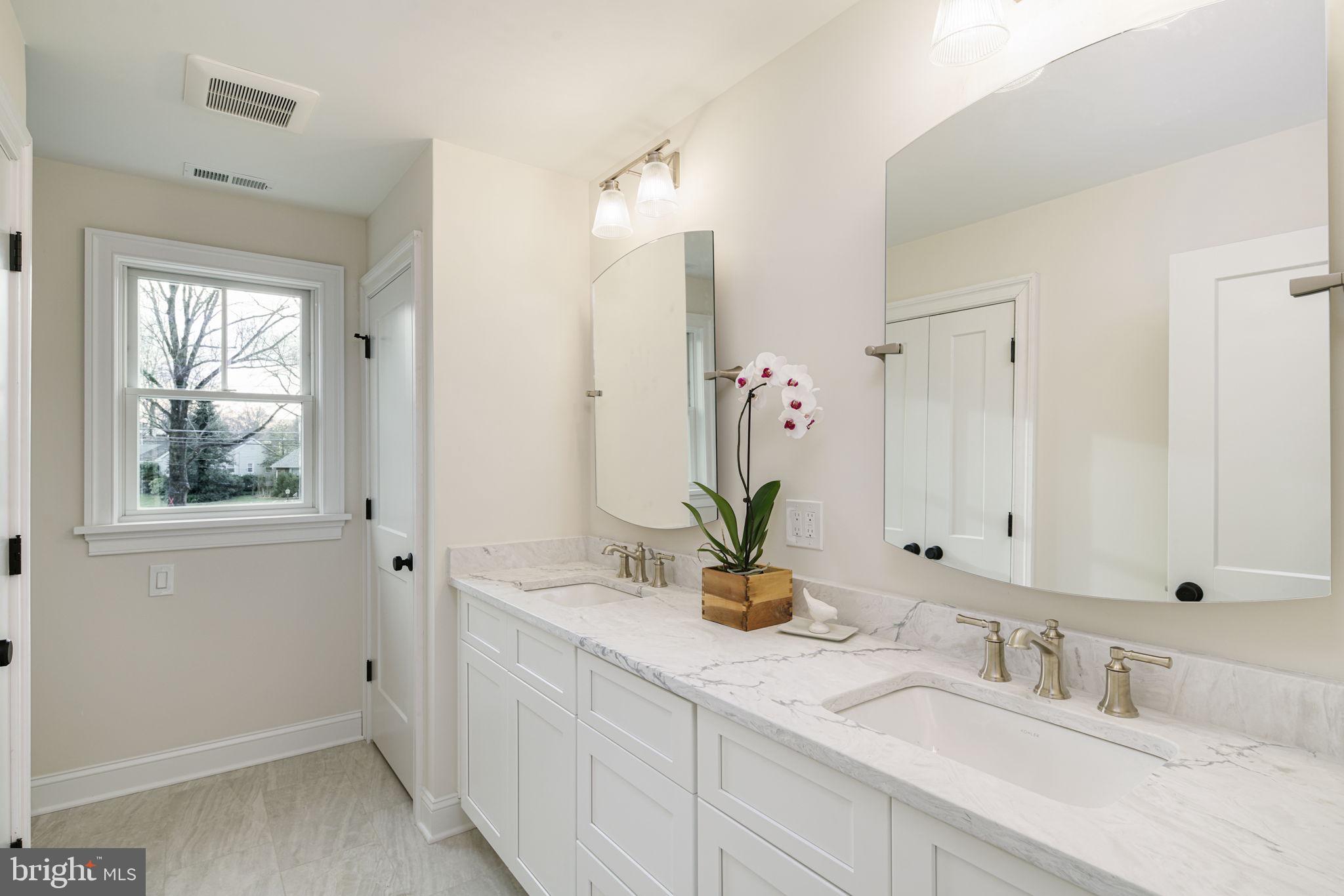 745 Cedar Avenue Haddonfield, NJ 08033 - Photo 31 of 55 a bathroom with double vanity sink and a mirror