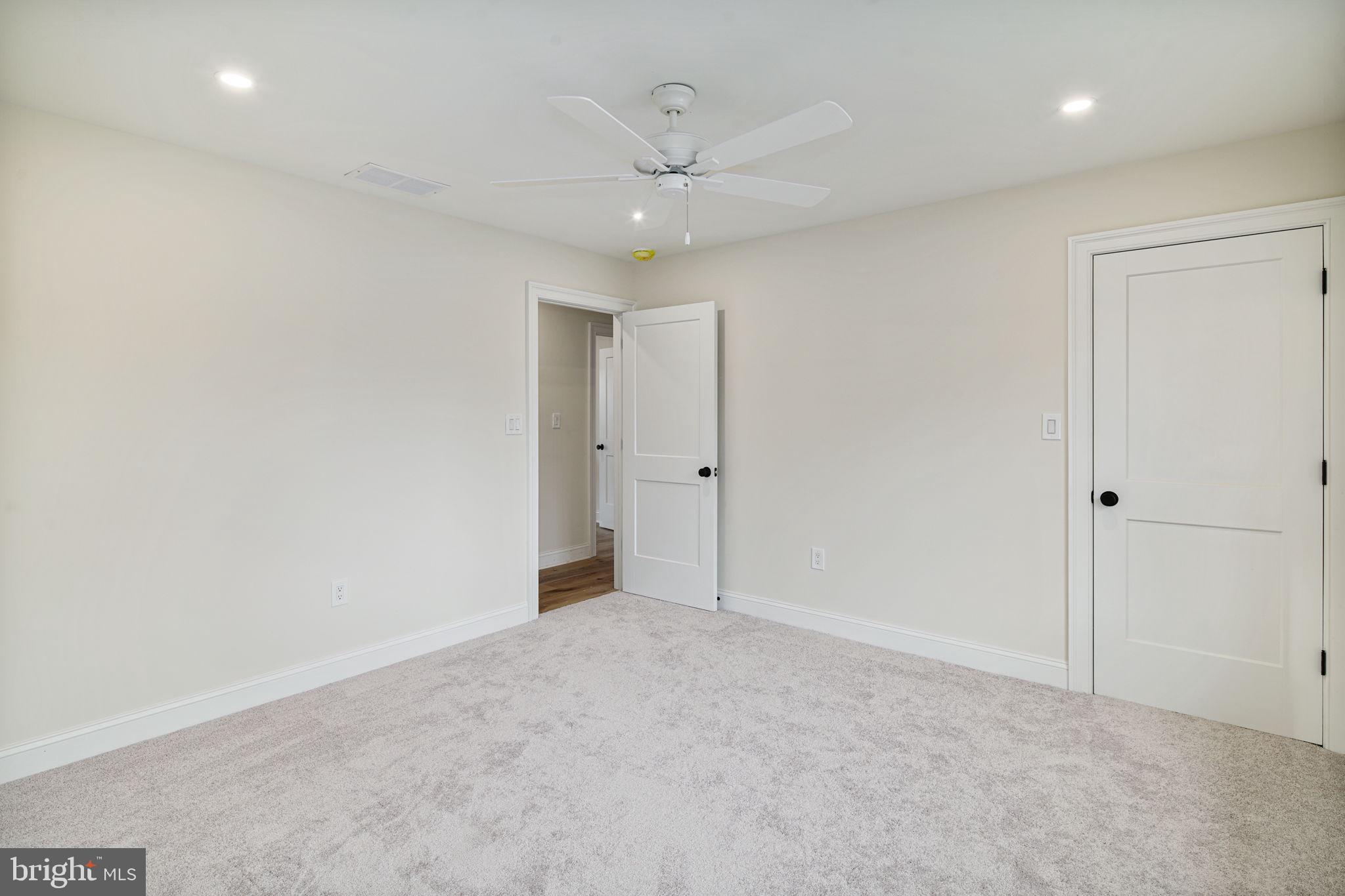 745 Cedar Avenue Haddonfield, NJ 08033 - Photo 38 of 55 an empty room with a ceiling fan and window
