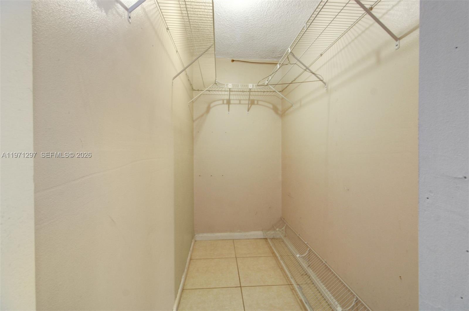 4717 Northwest 7th Street, Unit 60410 Miami, FL 33126 - Photo 14 of 19 a view of a room with racks on the wall