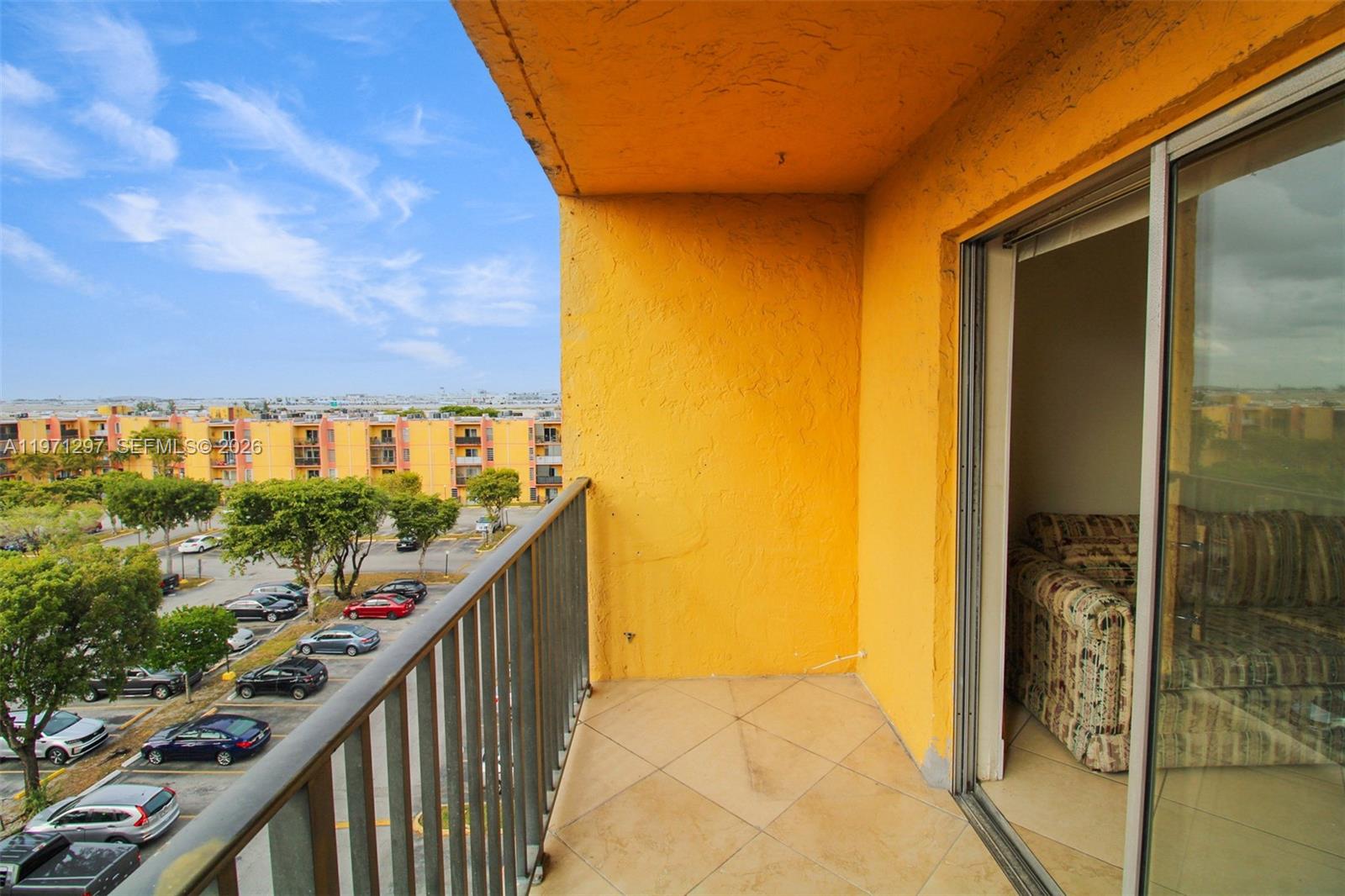 4717 Northwest 7th Street, Unit 60410 Miami, FL 33126 - Photo 16 of 19 a view of balcony with wooden floor and stairs