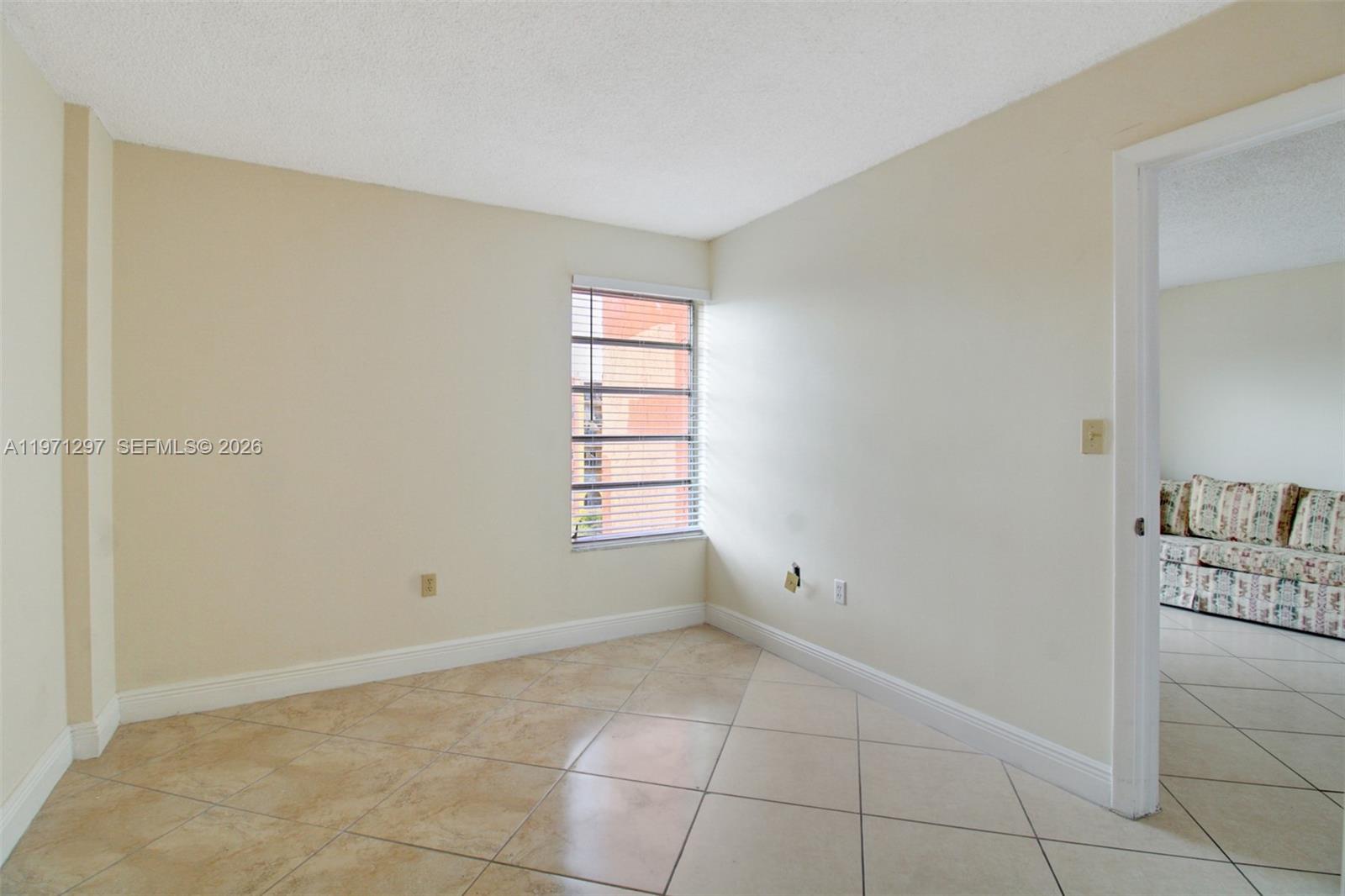 4717 Northwest 7th Street, Unit 60410 Miami, FL 33126 - Photo 9 of 19 an empty room with windows