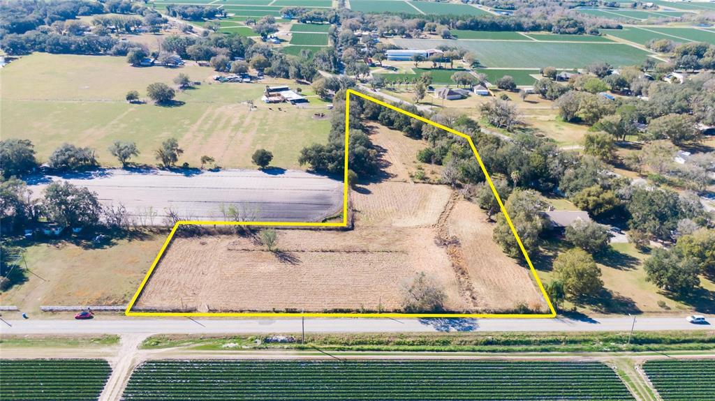 South Forbes Road Dover, FL 33527 - Photo 2 of 17 an aerial view of a house with a yard and lake view