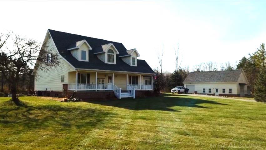 Cape Cod with Traditional Farm House Features. Large covered porch. Brick and Vinyl Siding.