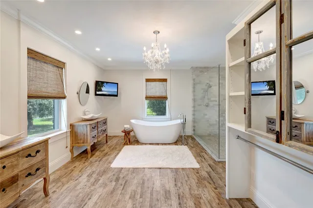 a bathroom with a sink a large mirror and a window