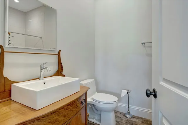 a white toilet sitting next to a bathroom sink