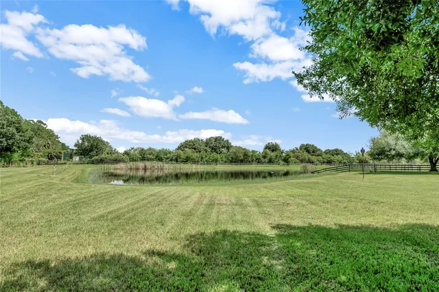 a view of a lake with houses in the back