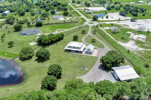 an aerial view of a house with yard swimming pool and outdoor seating
