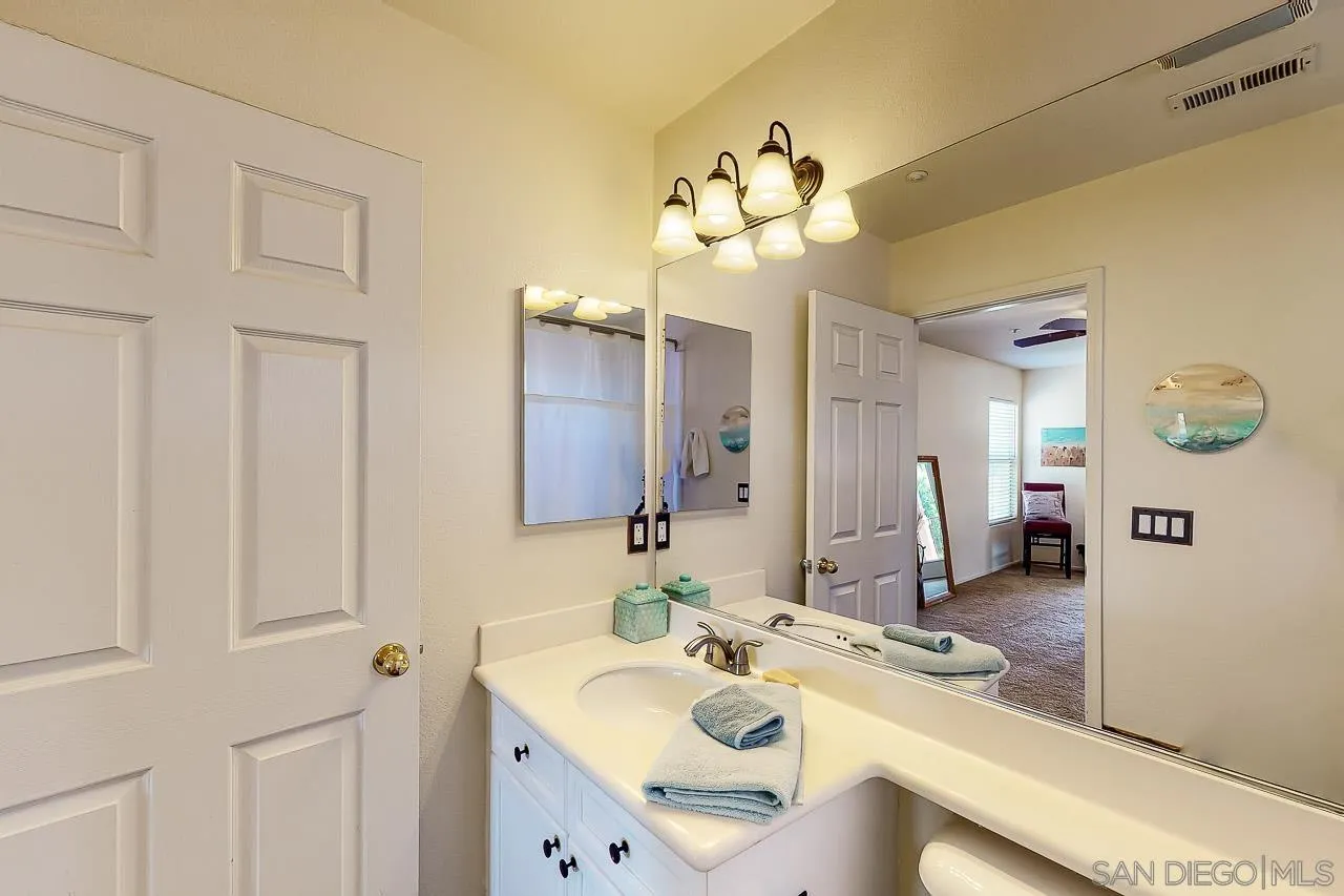 2477 Fallbrook Place Escondido, CA 92027 - Photo 15 of 28 a bathroom with a sink a double vanity and a mirror