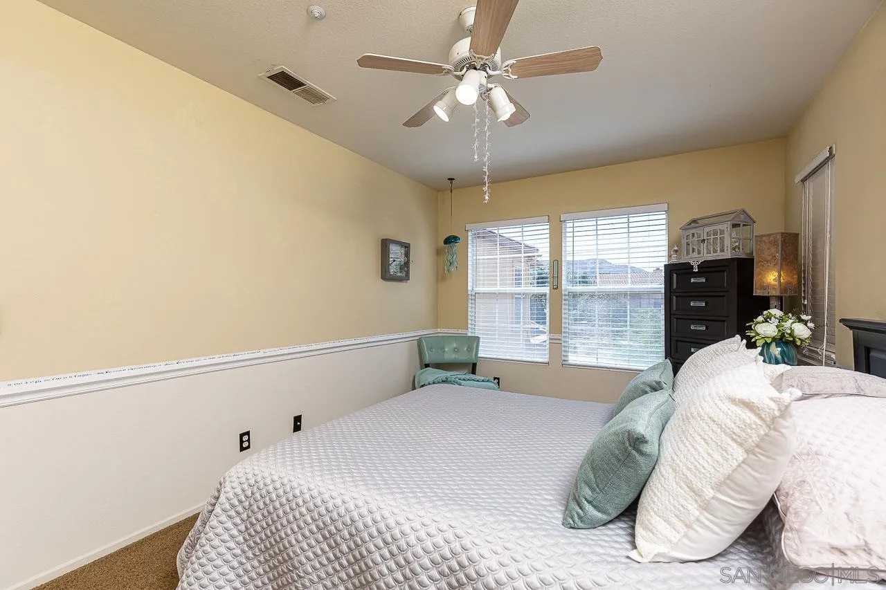 2477 Fallbrook Place Escondido, CA 92027 - Photo 23 of 28 a bedroom with a bed and a large window