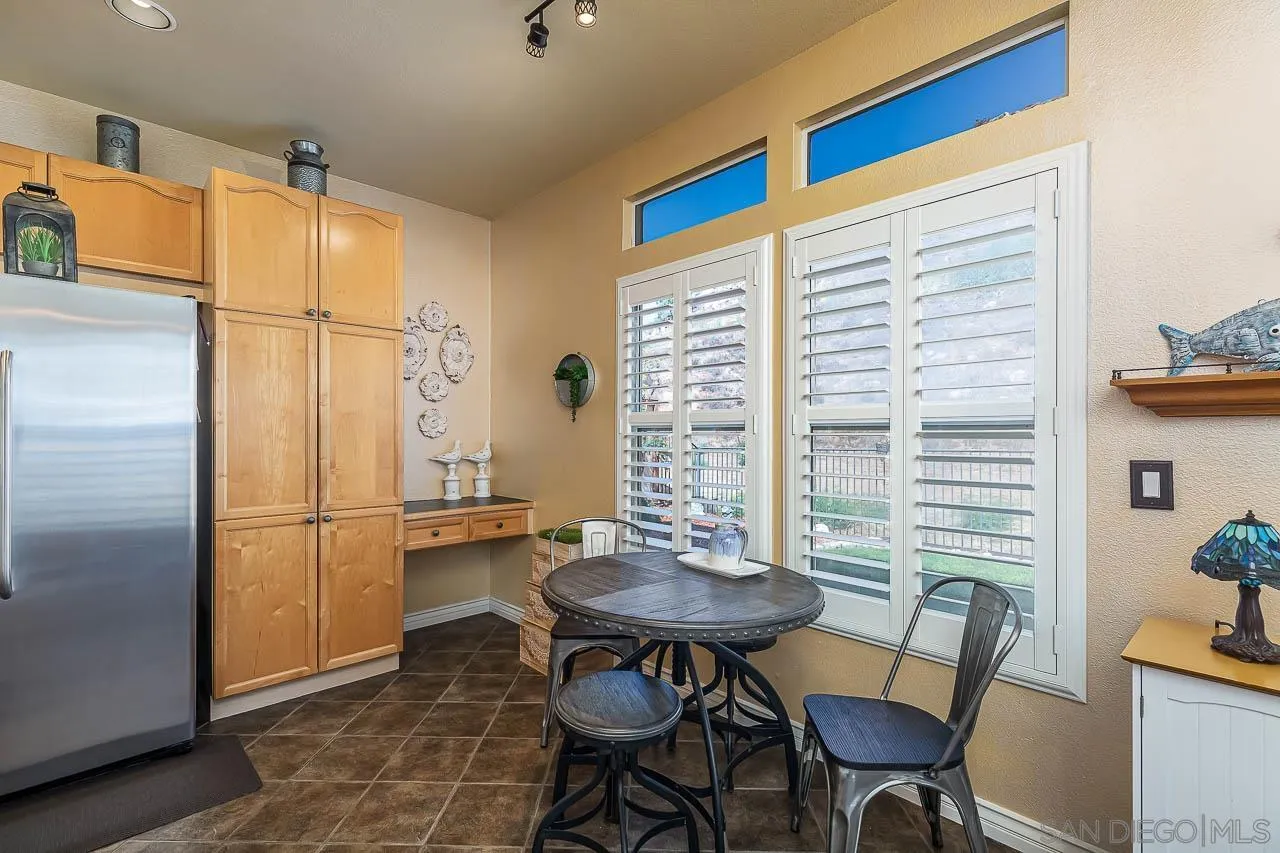 2477 Fallbrook Place Escondido, CA 92027 - Photo 9 of 28 a kitchen with a table and chairs in it