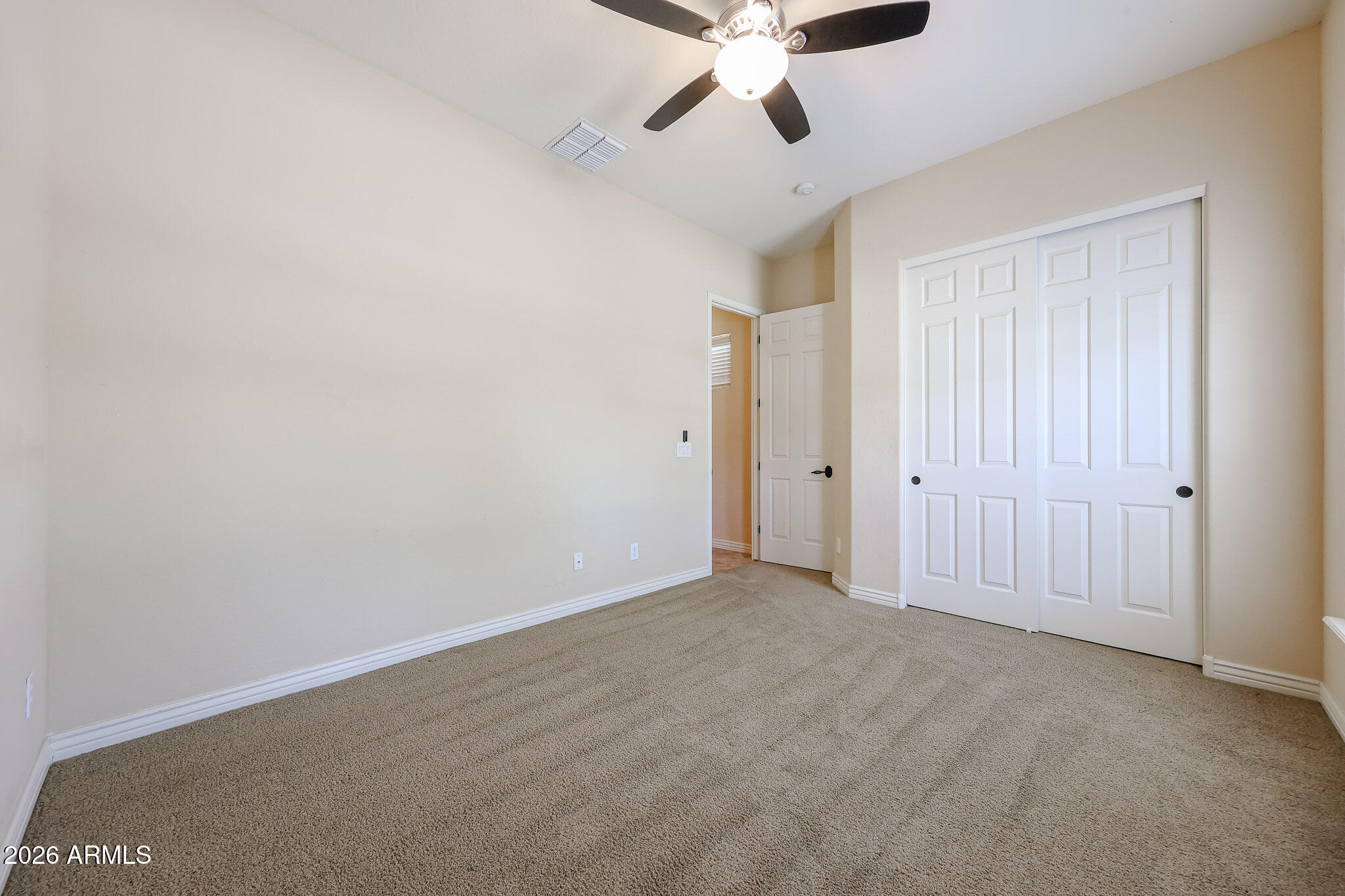 18175 West Narramore Road Goodyear, AZ 85338 - Photo 27 of 72 an empty room with a ceiling fan and a window