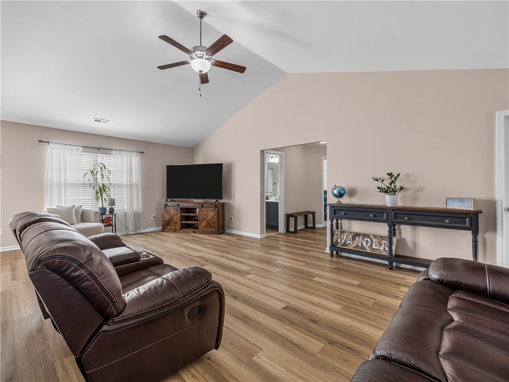 2520 Linmar Circle Anderson, SC 29621 - Photo 10 of 50 Natural light illuminates this spacious living area, featuring vaulted ceilings and durable wood flooring.