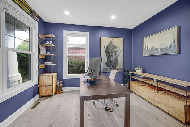 a work room with furniture and large window