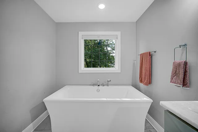 a white bath tub sitting next to a white sink