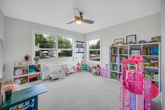 a bedroom with furniture and a book shelf