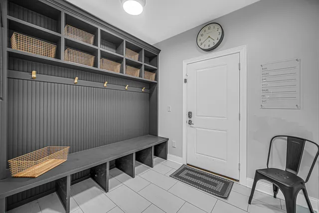 a view of a room with a lounge chair and a table