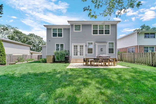 a view of a house with a yard and sitting area