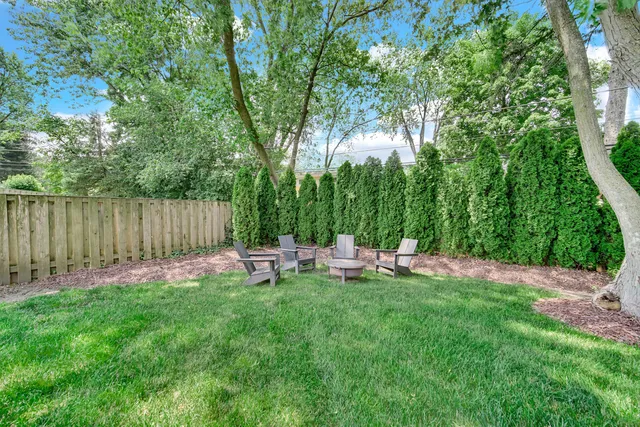 a view of a chairs and table in a yard