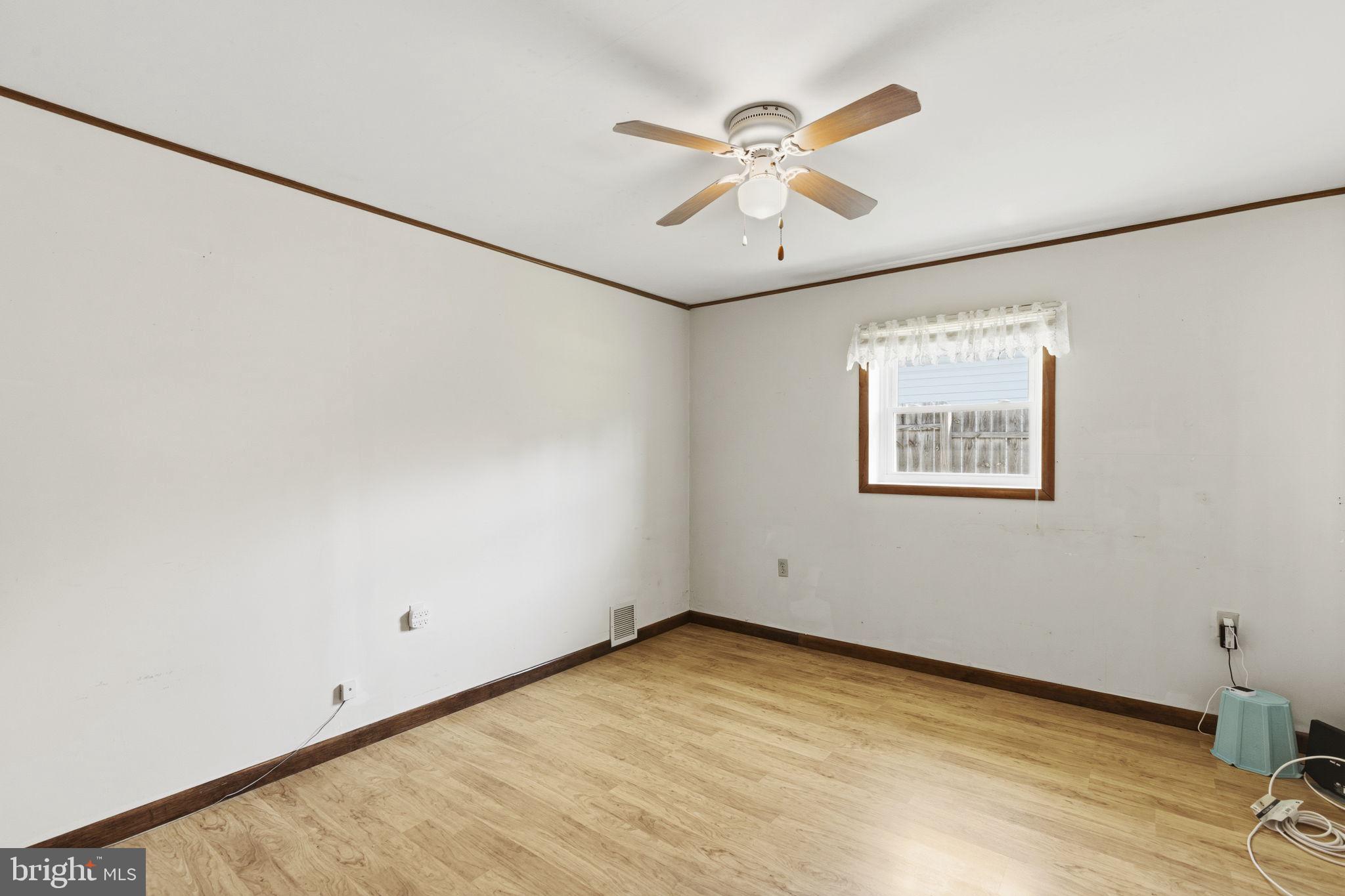 2411 Poplar Road Baltimore, MD 21221 - Photo 13 of 36 wooden floor in an empty room