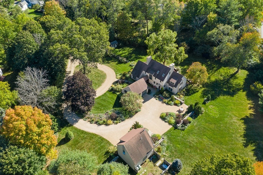 an aerial view of a house with a yard