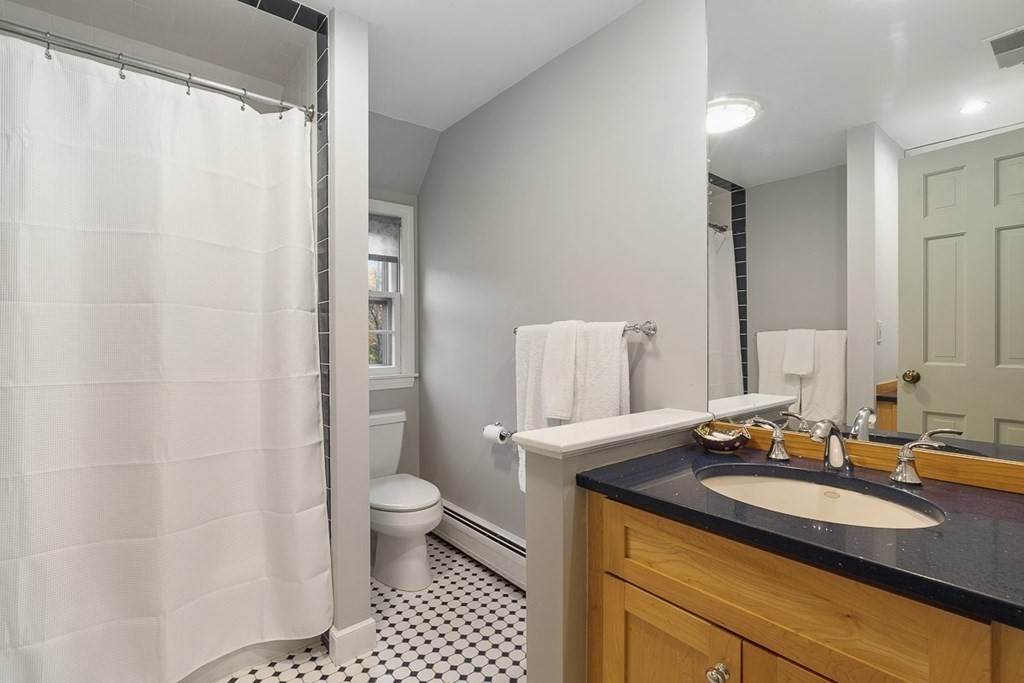 34 Barretts Mill Road Concord, MA 01742 - Photo 17 of 40 a bathroom with a sink a toilet and a mirror