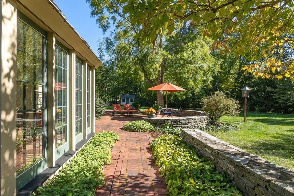 34 Barretts Mill Road Concord, MA 01742 - Photo 33 of 40 a view of swimming pool with lawn chairs under an umbrella