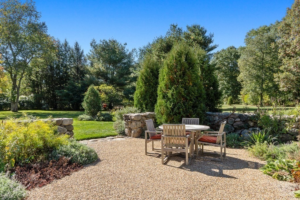 34 Barretts Mill Road Concord, MA 01742 - Photo 34 of 40 a view of a chair and table on the garden