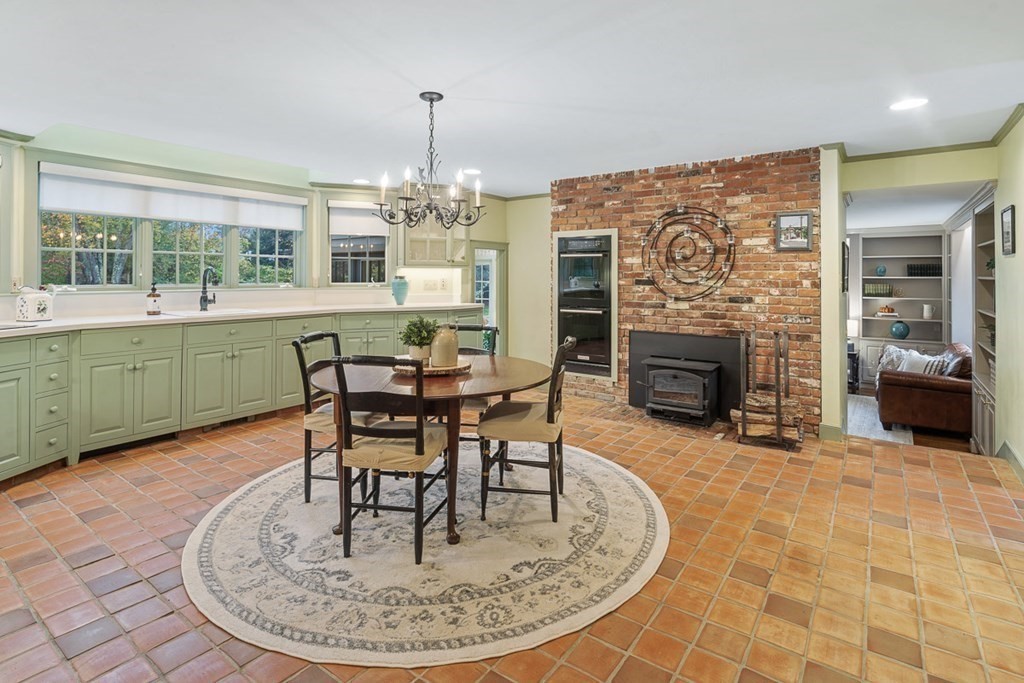 34 Barretts Mill Road Concord, MA 01742 - Photo 9 of 40 a dining room with furniture a fireplace and chandelier